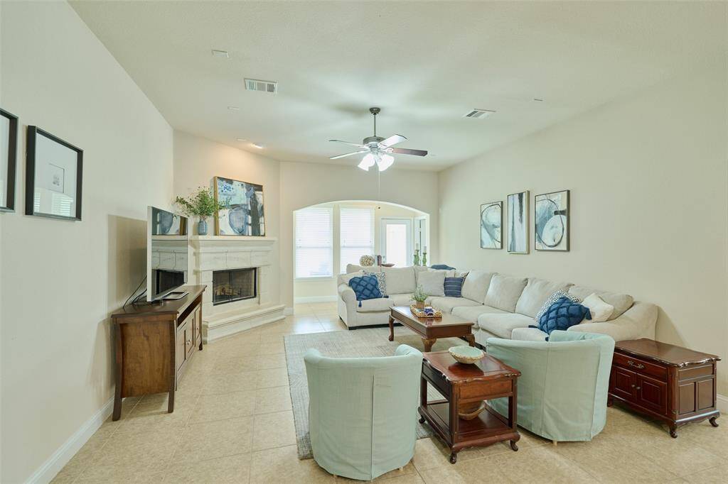 The primary suite is tucked privately in the back of the home