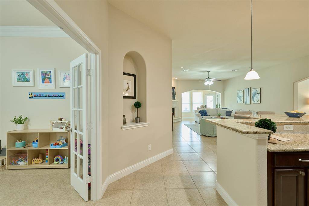 Light and bright open floorplan with flexible spaces throughout. The home office/study with French doors just off the kitchen is currently being used as a playroom.