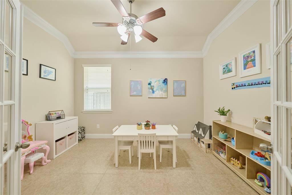 Study/home office with French doors currently being used as a playroom.