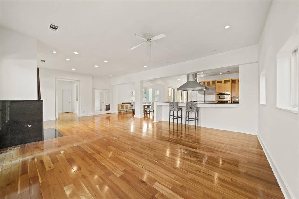 View from living room to dining, kitchen and additional seating available at kitchen bar. High ceilings and a true open floor plan.