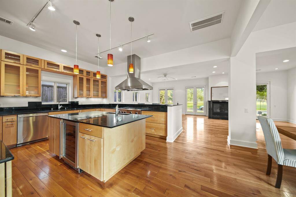 Separate granite island and cabinets with glass front.
