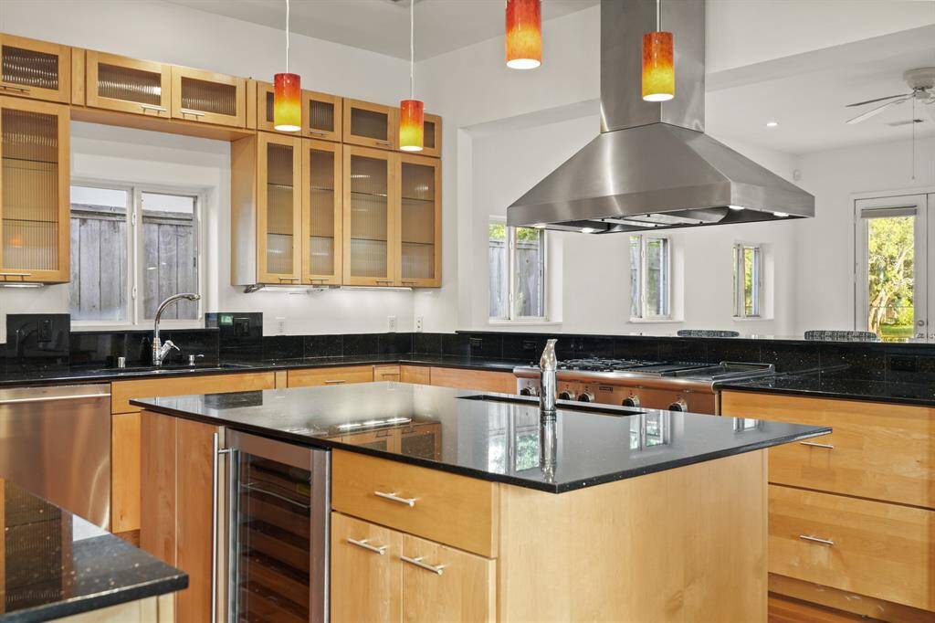 Wine chiller installed in the kitchen island, additional storage in the kitchen island, and sink for vegetable prep.