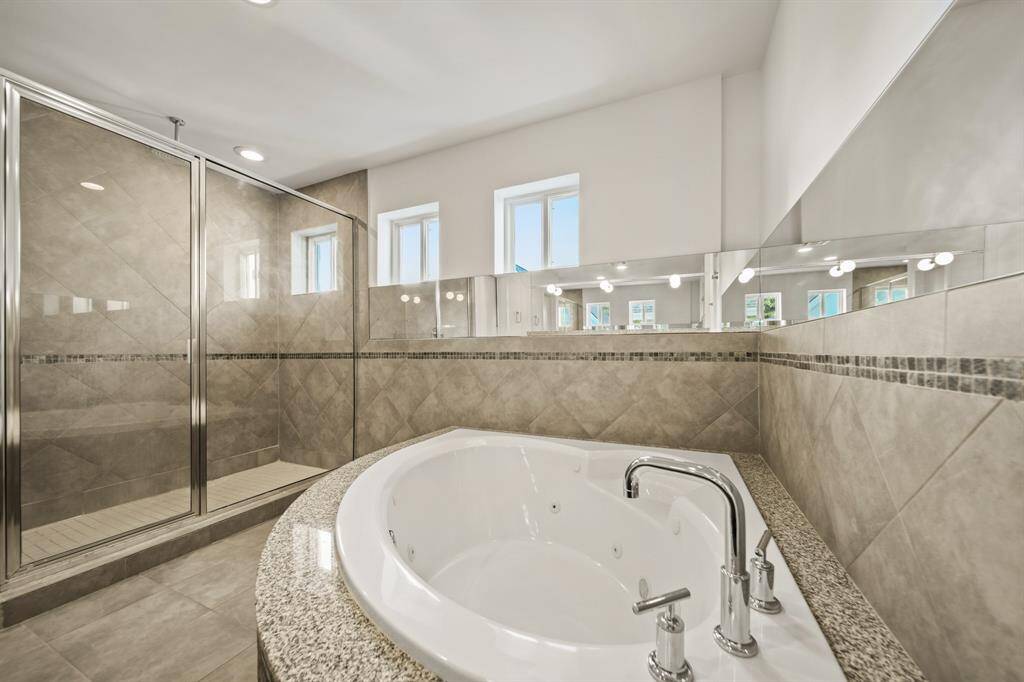 Primary bathroom with stand alone rain shower and soaking tub.