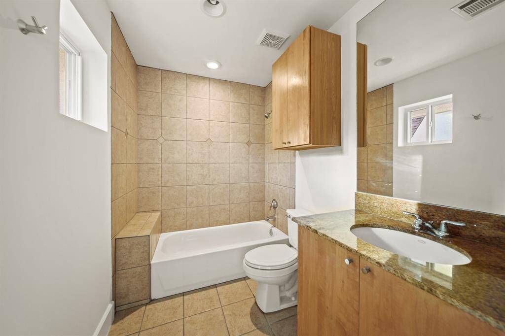 Bathroom with direct access to bedroom with granite countertops and shower/tub combo.