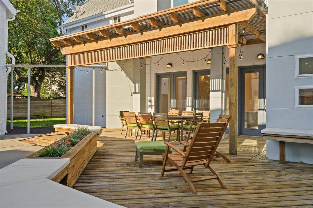 Back patio with covered structure and French door access from patio into home.