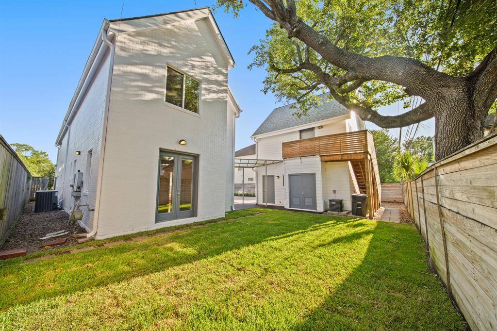 Backyard view of home and garage/guest quarters with utility room.