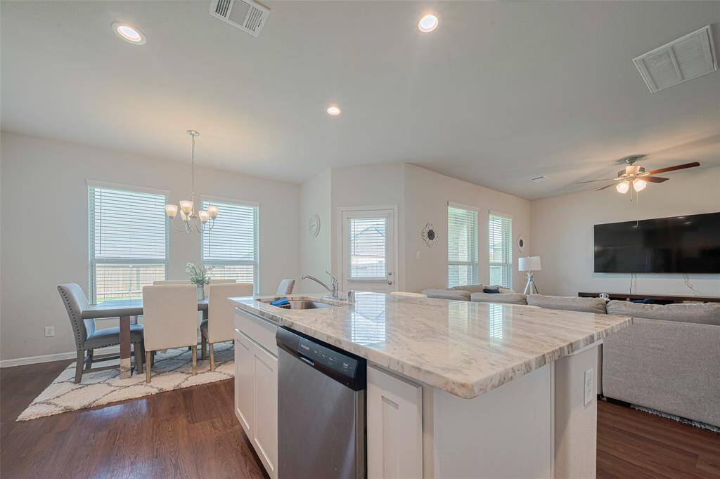From the kitchen, enjoy an uninterrupted view of the sunlit living and dining areas.