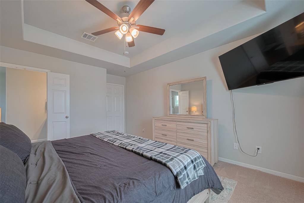 This image captures the thoughtful flow between the bedroom, its entry, and the en suite bath.