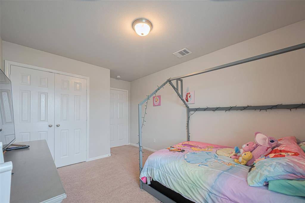 Seen from another angle, this secondary bedroom reveals its entry door and closet.