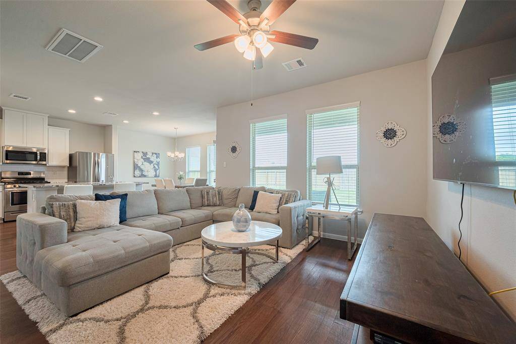This angle showcases the flow between the living area, kitchen, and dining space, highlighting the home’s open-concept design that feels both expansive and connected.