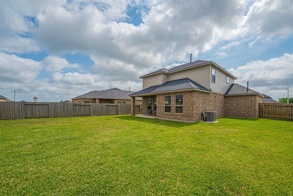 Another look at the rear elevation reveals the generous proportions of the backyard, ready for gatherings or play.