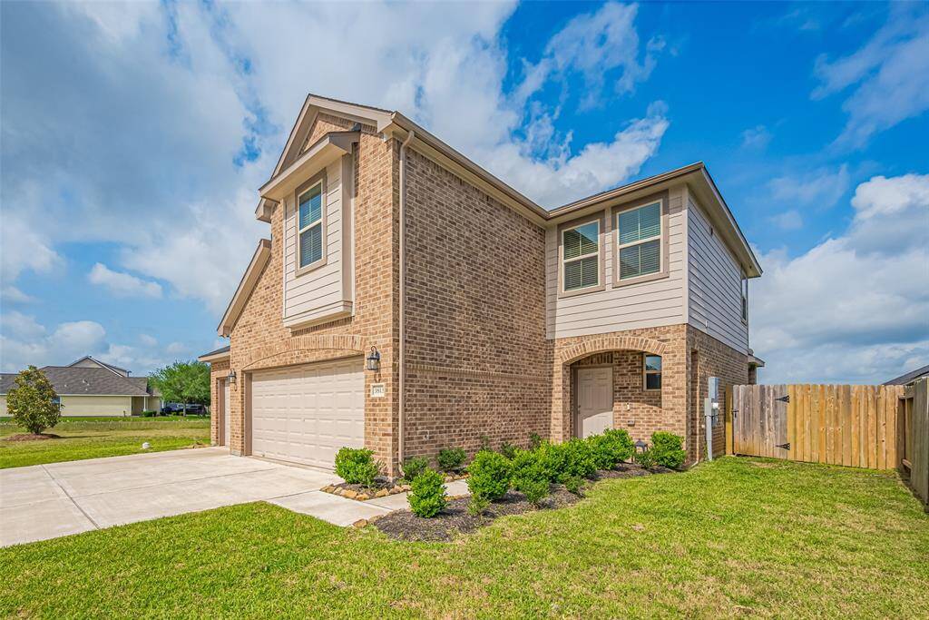 The recessed front entry is framed by a graceful brick archway, creating a warm welcome before you even step inside.