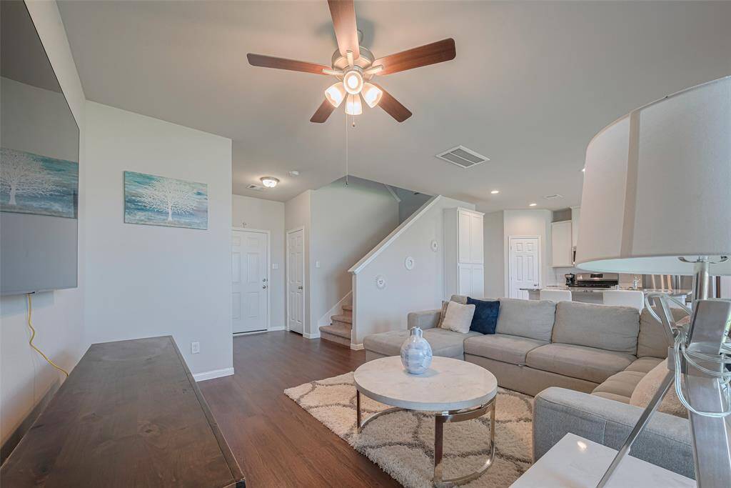 A view from the living room toward the staircase and front entry.