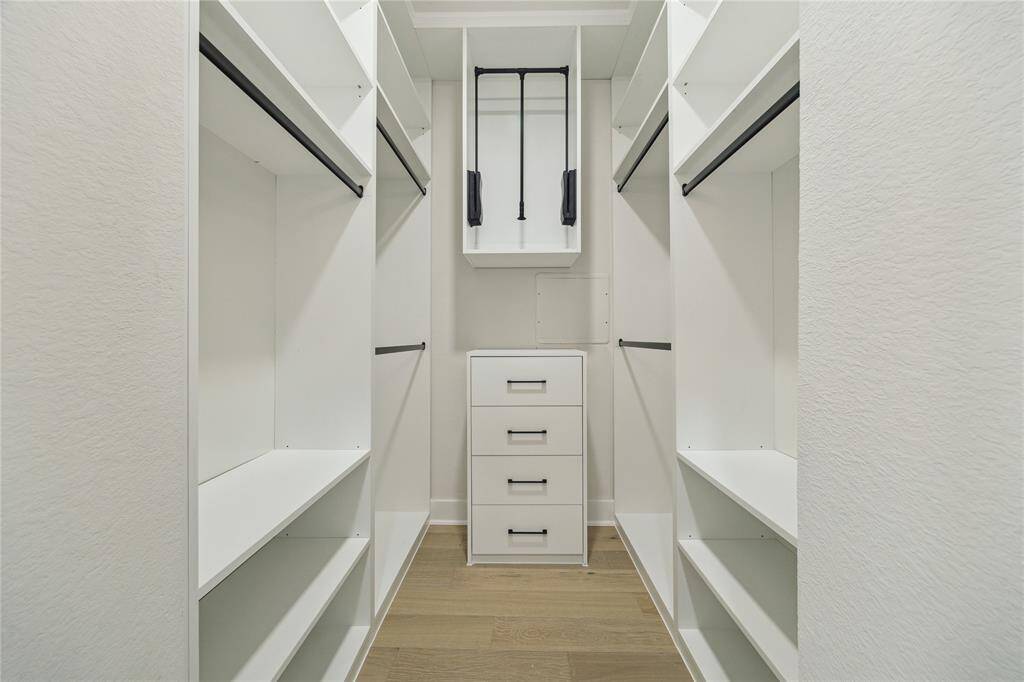 Spacious dual primary closets offer ample storage and organization.