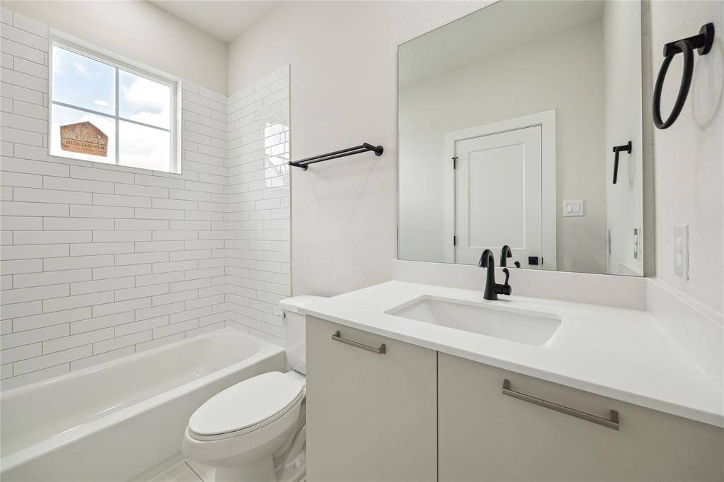 Bright and modern third-floor bathroom featuring sleek fixtures and a stylish, tiled shower.