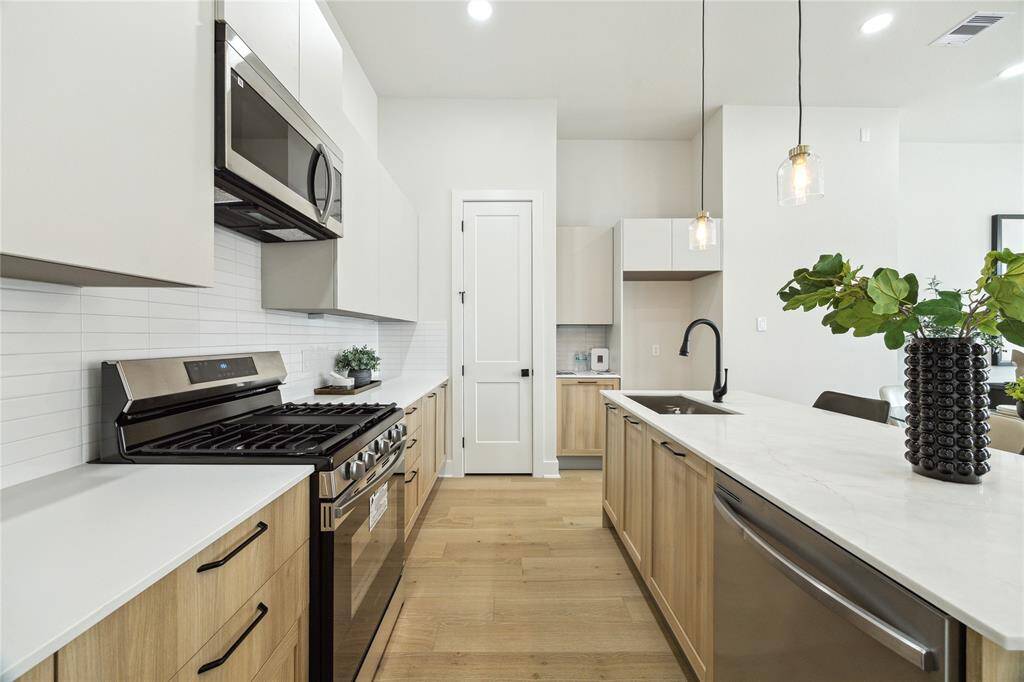 Explore this modern kitchen featuring sleek cabinetry, high-end appliances, and a spacious island perfect for cooking and entertaining.