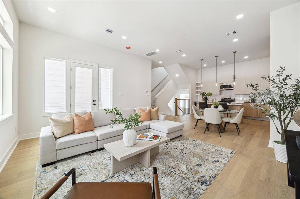 Experience seamless living in this open-concept space, featuring a bright living area, elegant dining space, and a modern kitchen perfect for entertaining.