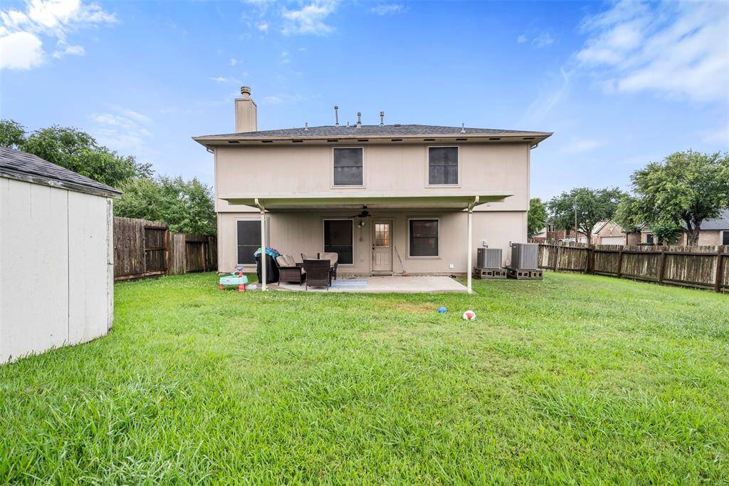 Fully fenced backyard with shed