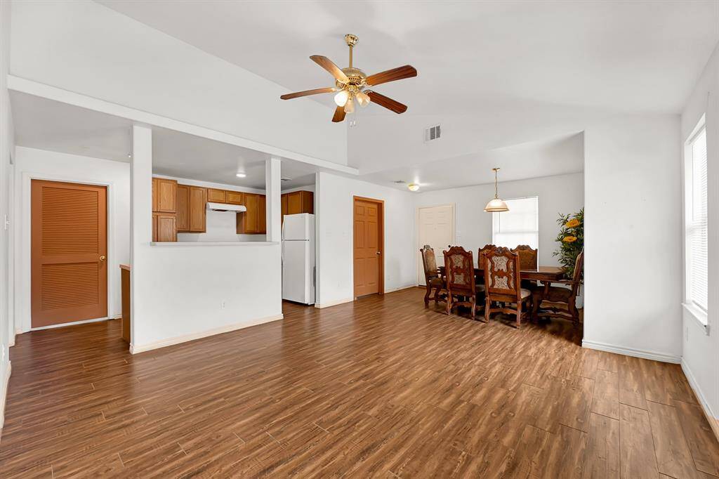 Living room area flowing into the kitchen and dining room.