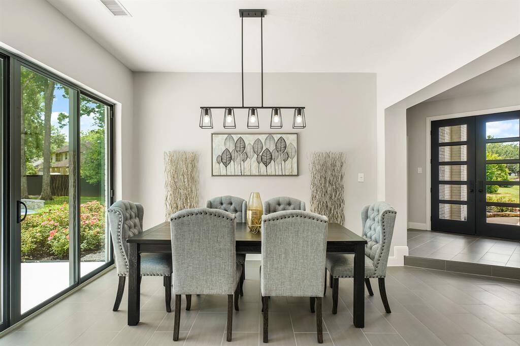 The Dining Room is light and bright thanks to the sunlight filtering in from both the front doors and the sliding glass doors to the Backyard. The space is large enough to accommodate a large table, in addition to a buffet or drink cart.