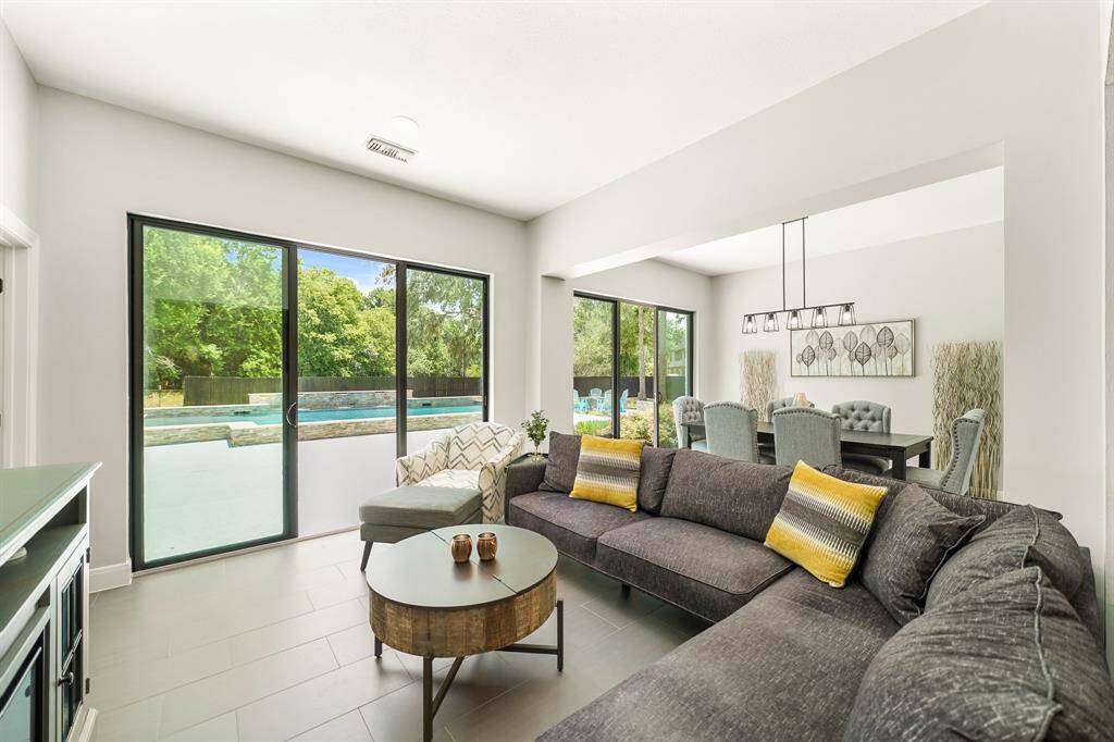 The main living space is treated to a resort-like view thanks to the two sliding glass doors that provide direct access to the Backyard Pool. Open them up on a nice day and enjoy a warm breeze and the soothing sounds of the tricking waterfall.