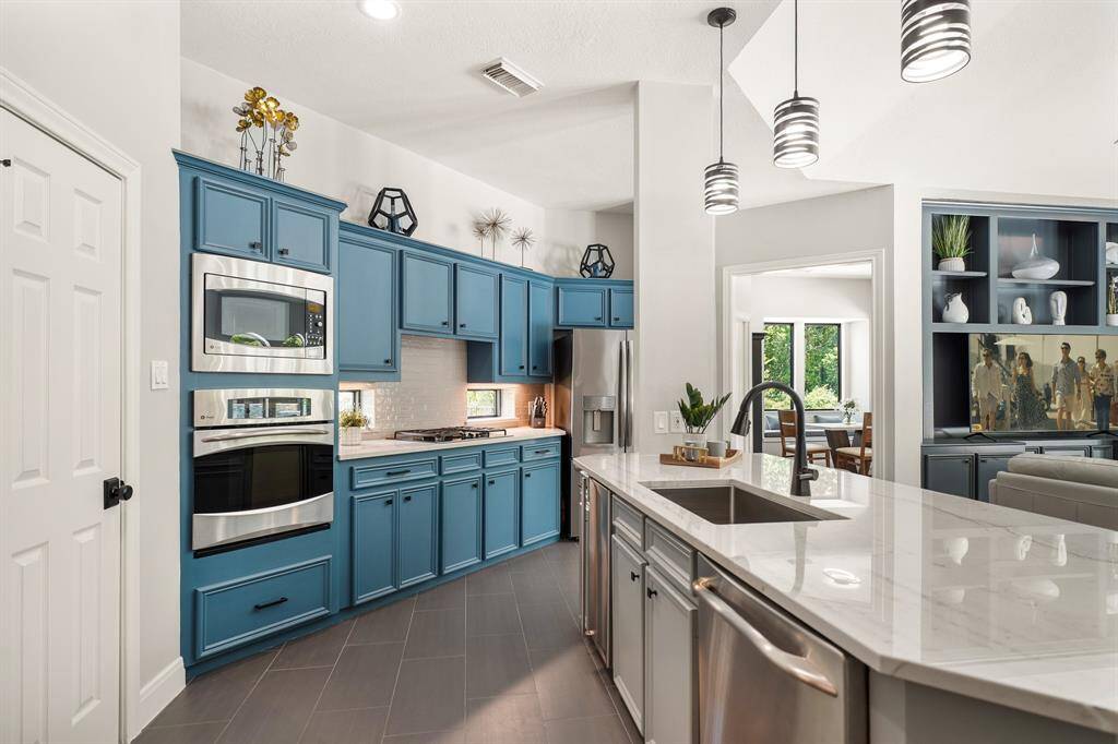 The home chef is sure to feel right at home in the comfort of this high-end Kitchen. The freshly painted azure blue cabinets add a welcomed pop of color against the gray subway tile backsplash and quartzite countertops.