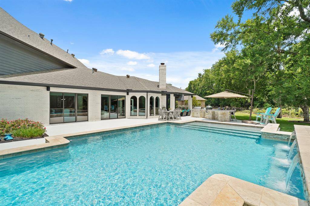 Let’s take a sneak peek at this spacious Backyard Pool, equipped with tanning ledge and waterfall features. Summer is officially here, and this Pool is calling your name!