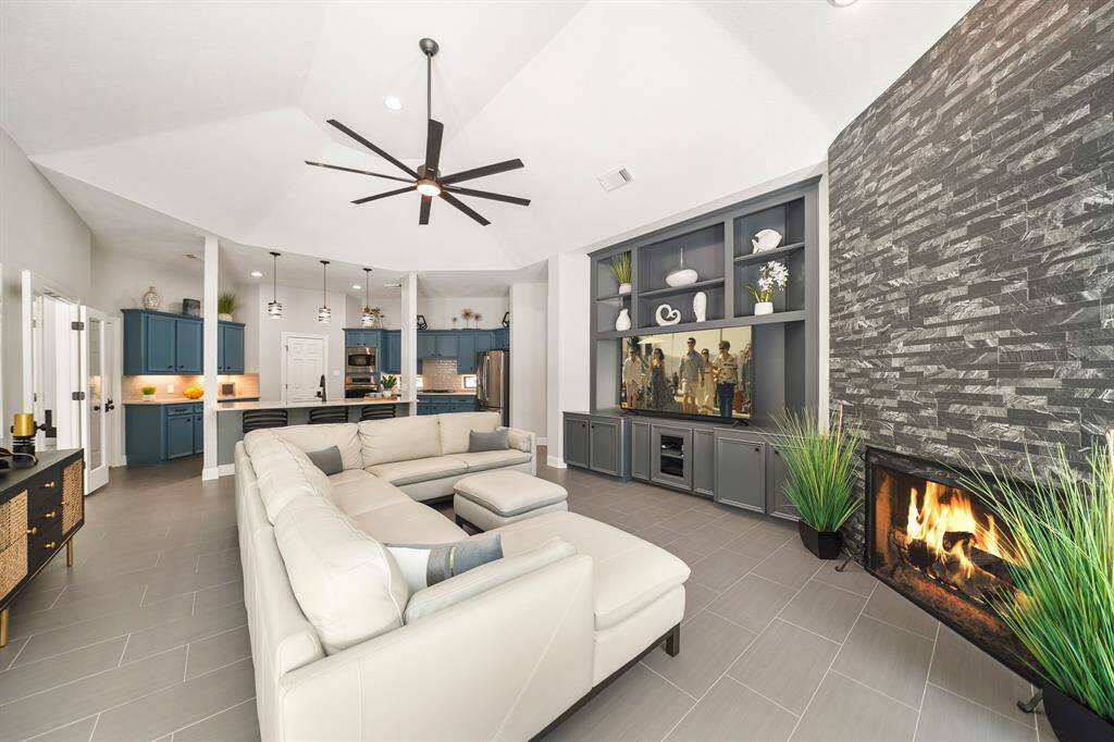 Custom built-ins provide an abundance of both open and closed storage. This is a great place to hide gaming consoles, board games, and toys, while displaying family pictures and travel mementos.
