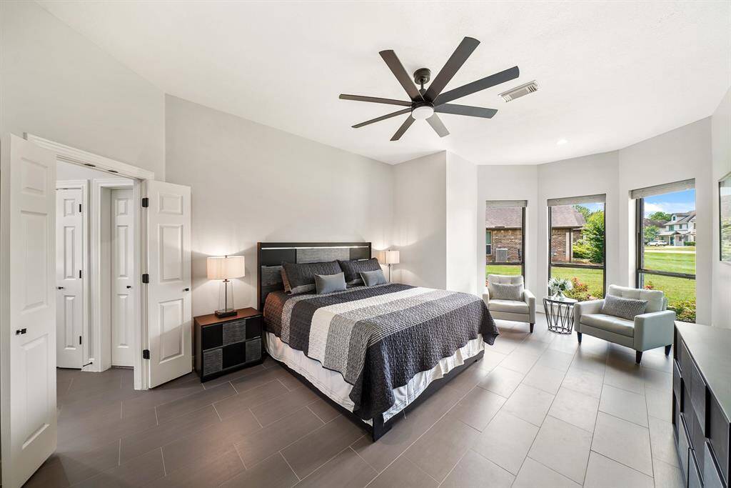 Unwind at the end of a long day in the comfort of this spacious Primary Retreat. The space boasts continued tile flooring, an oversized fan, and a trio of windows overlooking the Front Yard. The room is large in size and can easily accommodate additional furniture like a dresser, armoire, or pair of cozy chairs.