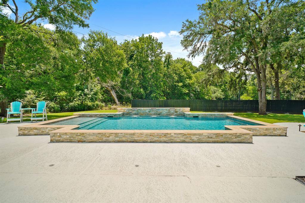 This picture-perfect, slightly raised chlorine Pool boasts a stacked stone siding, tanning ledge, and waterfall feature. The Pool reaches a max depth of 4 1/2 feet, making it ideal for jumping, splashing, and a family game of water volleyball.