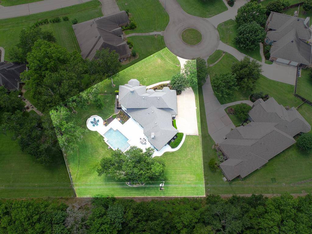 This bird’s eye view showcases the home’s prime location at the end of a quiet cul-de-sac, surrounded by mature trees, and no rear neighbors.