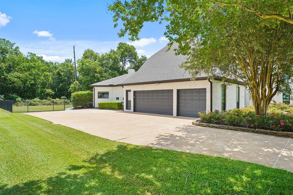 The long driveway extends beyond the oversized, 3-car Garage, providing additional parking and a safe place for kids to shoot hoops or ride bikes. A side gate allows for direct access to the home’s fully fenced Backyard.