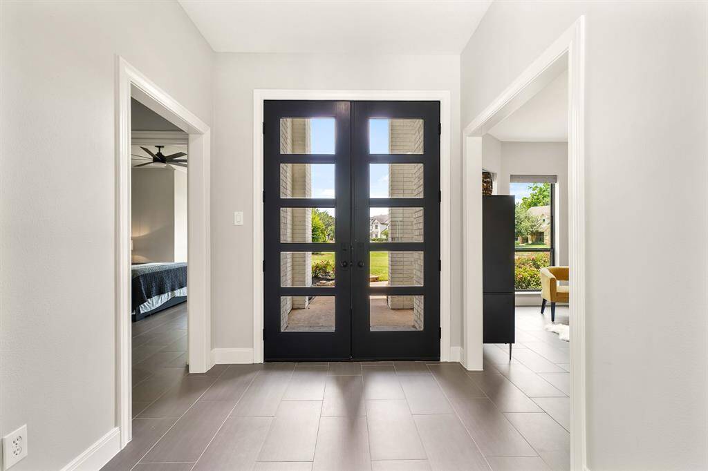 This look back highlights the abundance of natural light that floods into the Foyer, making the space feel light and bright. The cased opening to the left leads to the Primary Retreat, while the cased opening to the right leads to the Study.