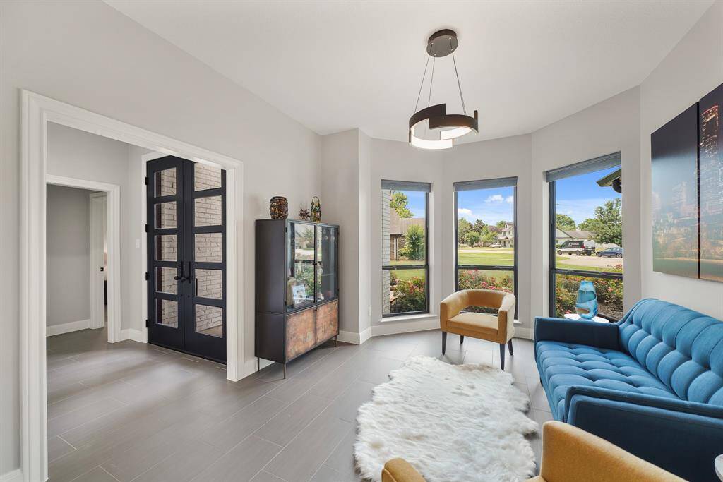 This bright and brilliant Study is located directly off the Foyer. The space boasts tile flooring, a trio of front facing windows, upgraded, modern light fixture, and direct access to the downstairs Full Bath.