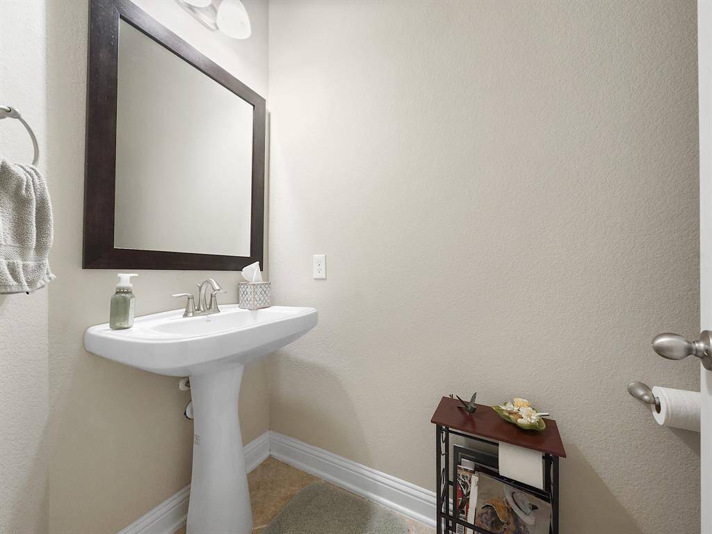 Powder room with pedestal sink on the main floor.
