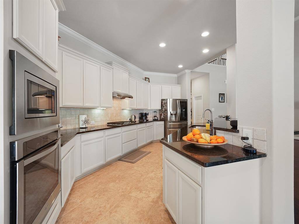 Classic black and white kitchen with stainless steel appliances.