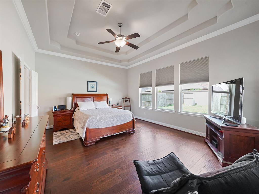 There are two primary bedrooms in the house, but this is the THE PRIMARY. Elegant tray ceiling details, crown molding and decked out en suite bath.