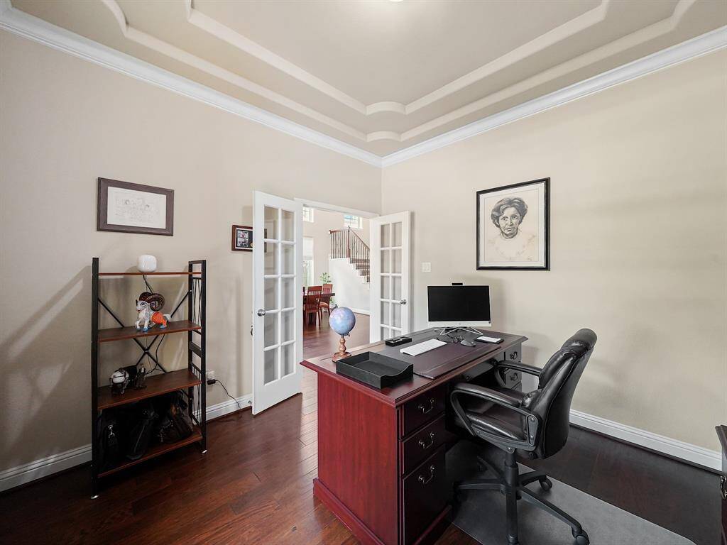 Home office located to your right as you enter the home. Beautiful ceiling detail and engineered hardwoods.
