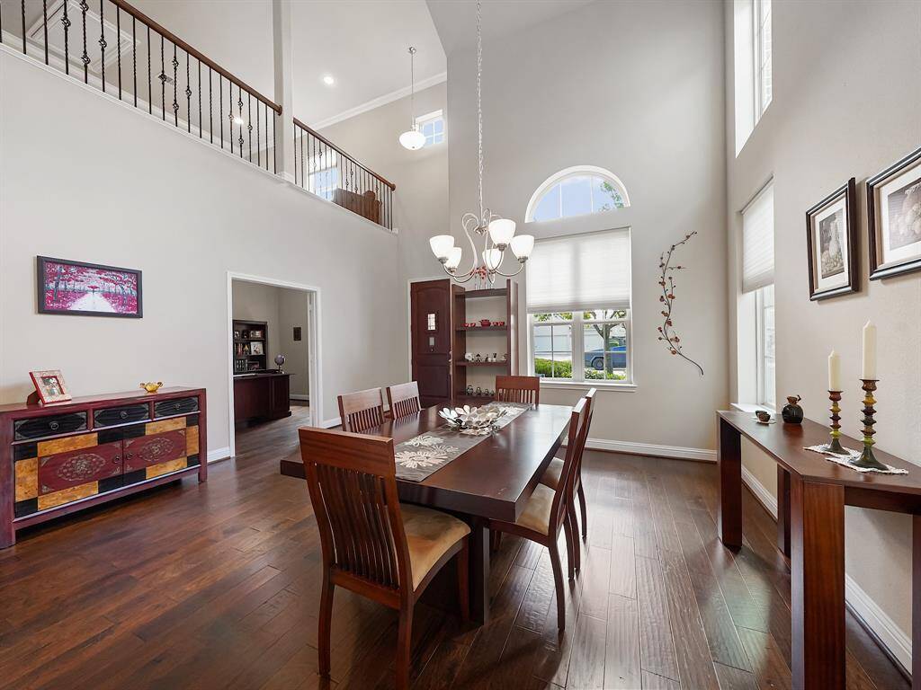 View from the dining room toward the home office and front door.  Upstairs game room overlooks this area.