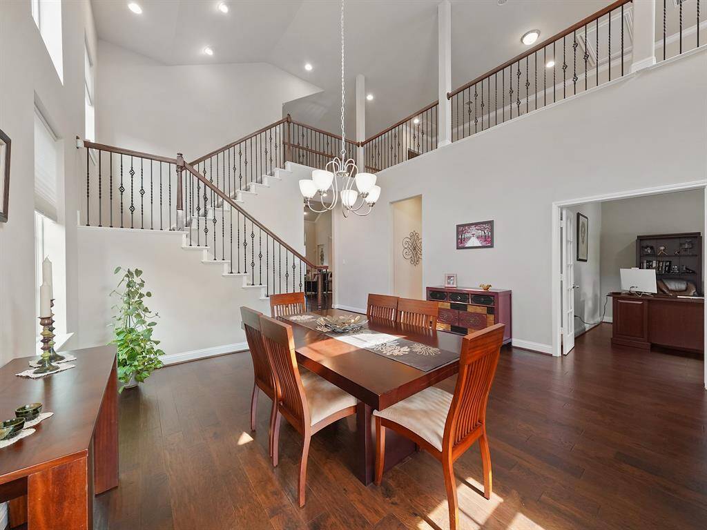 Stunning wrought iron and wood banister weaves its way upstairs.