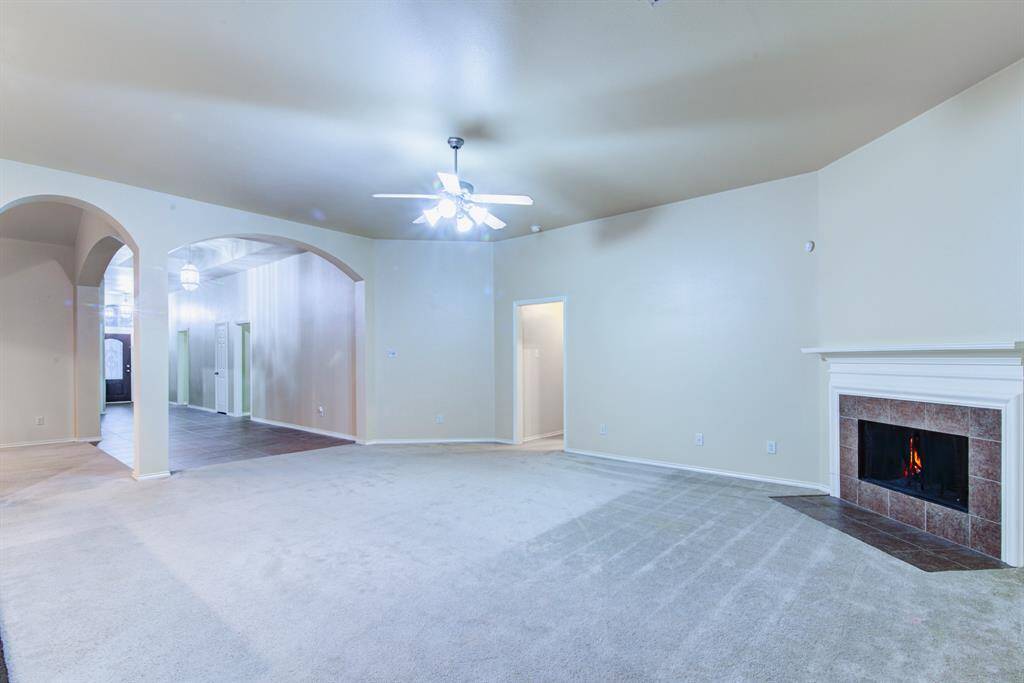From the main living area you have a clear view to the front door through the overside entry. Archtechural arches lead into the formal dining area.