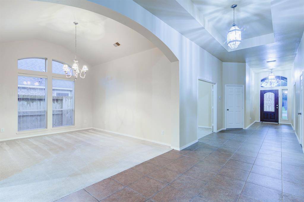 Another view of the formal dining area and the grand entryway.