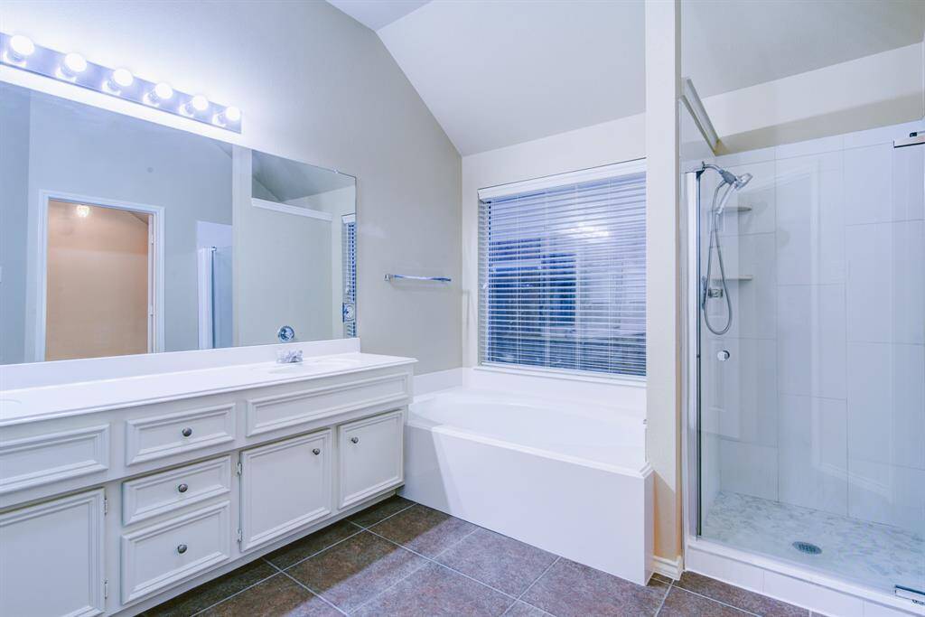 Walk-in shower, soaking tub and double vanity with storage, yes please!
