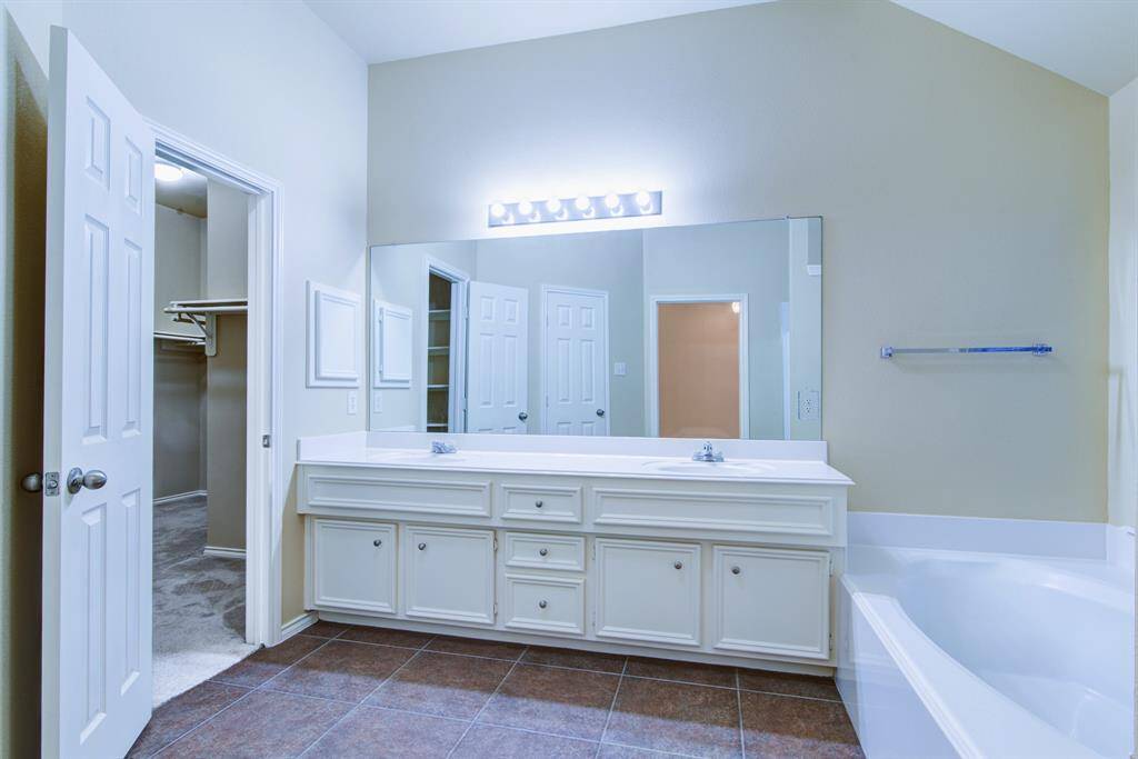 To the left of the double vanity is a mega walk-in closet.