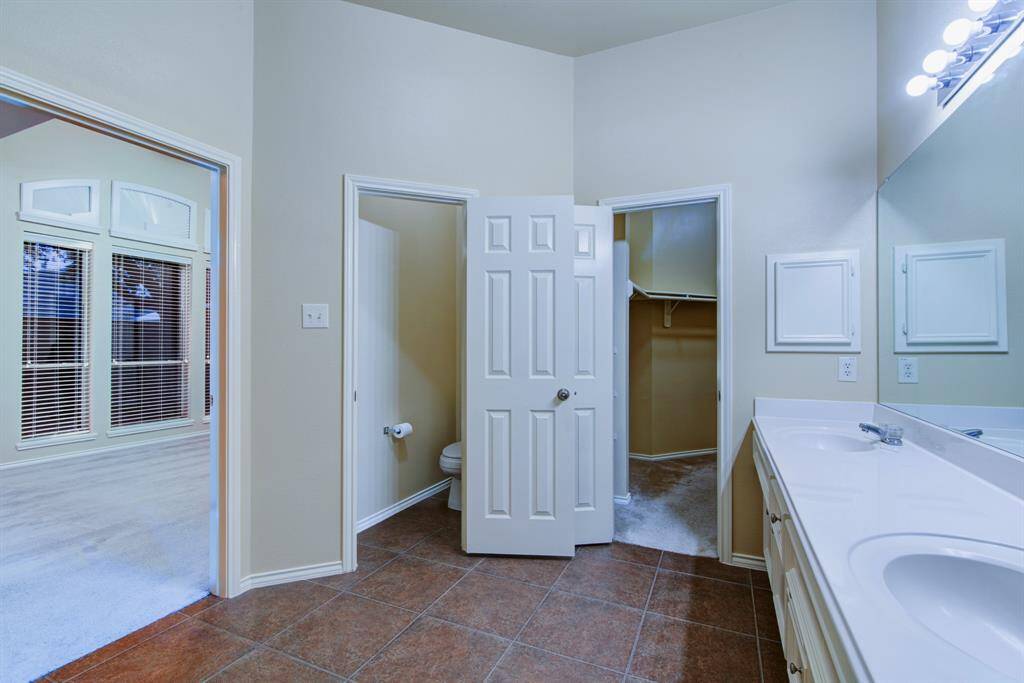 To the left of the closet is a private water closet.