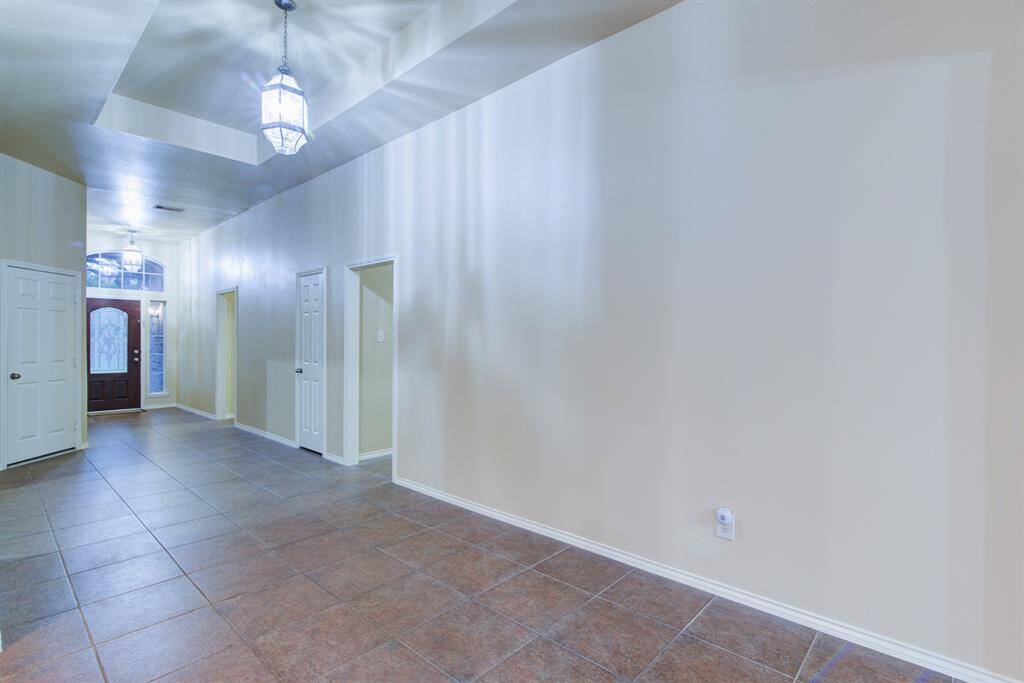 From this view the first door to the right leads to the laundry room and private guest suite. The second door to the right leads to the three front bedrooms.