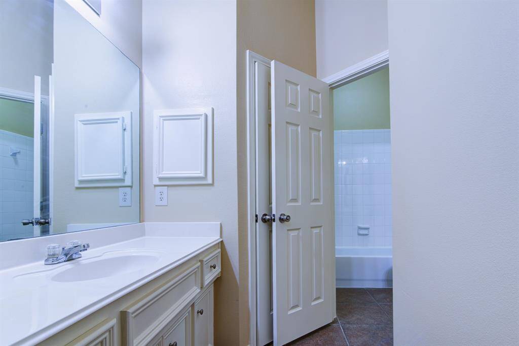 Lots of counter and storage space in this bathroom connected to the front bedroom.