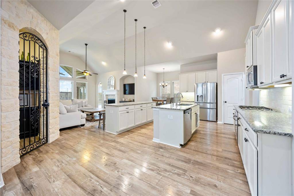 The kitchen flows seamlessly into the dining and living areas, creating a spacious, connected layout.
