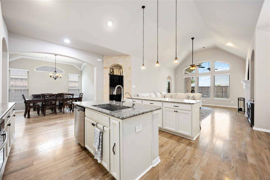 A large granite-topped island offers ample prep space and serving as a focal point for gatherings.