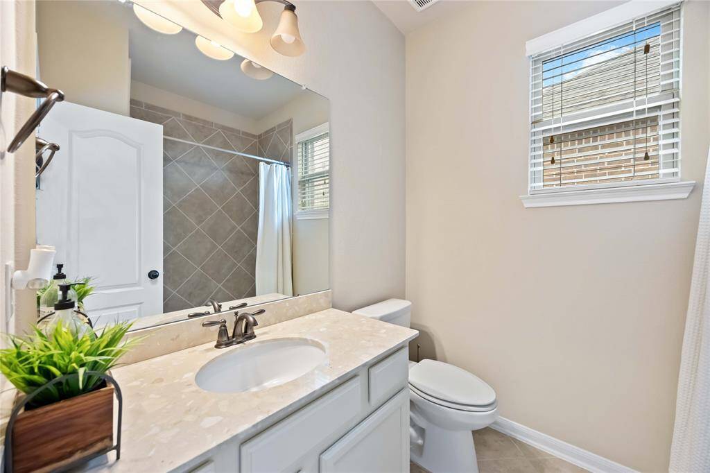 Attached to Bedroom 3, this private bath offers a versatile tub and shower combo.
